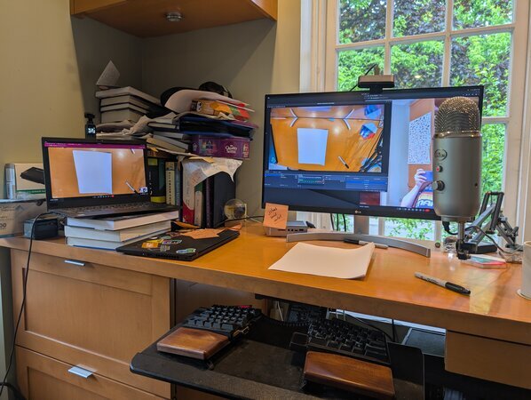 My recording setup showing webcam pointing down at desk, with laptop and second camera visible
